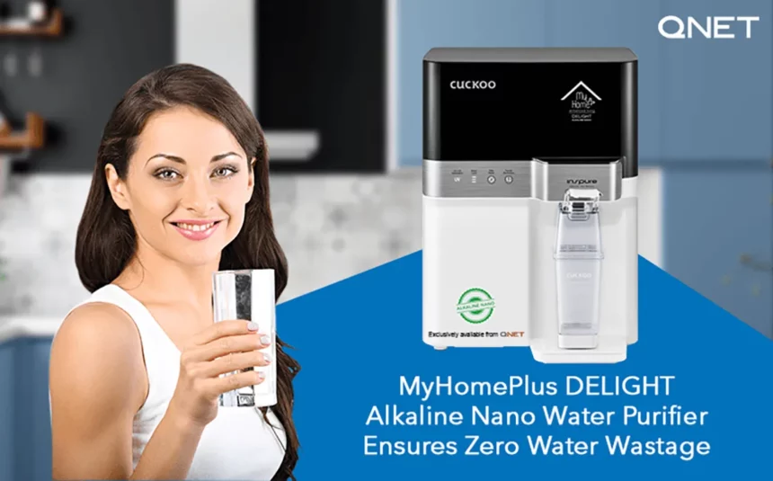 A young woman drinking water in her kitchen with MyHomePlus DELIGHT – Alkaline Nano Water Purifier in the frame