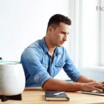 A young man working on his laptop next to Homepure Zayn