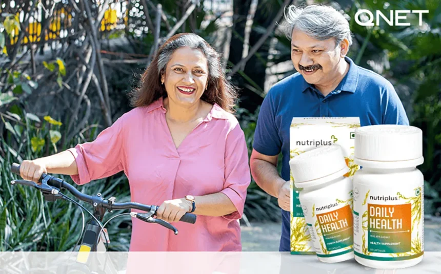 An elderly couple walking in the park with their bicycle