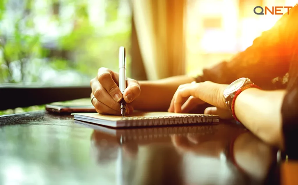 A woman making notes in her journal during her morning routine