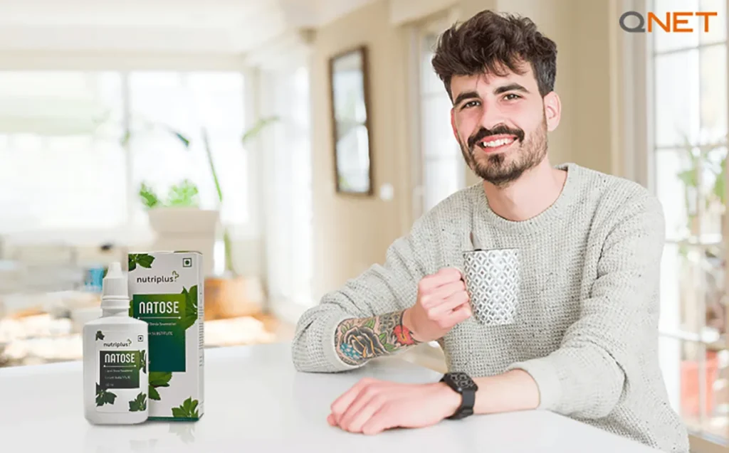 A young man enjoying a cup of refreshing green tea featuring Nutriplus Natose