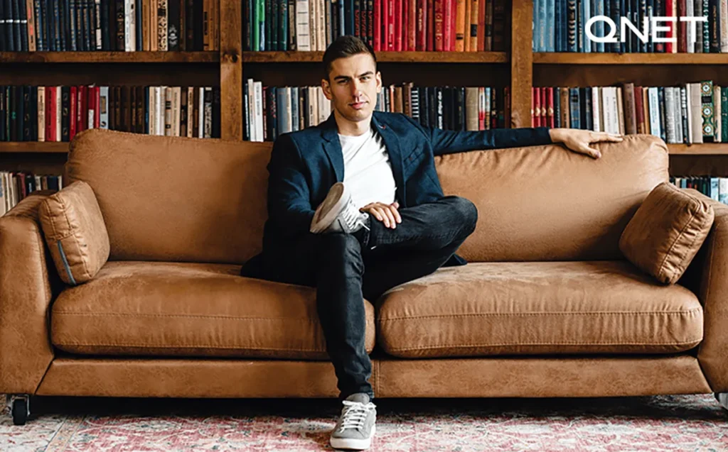 Well-dressed businessman sitting on sofa | QNET India