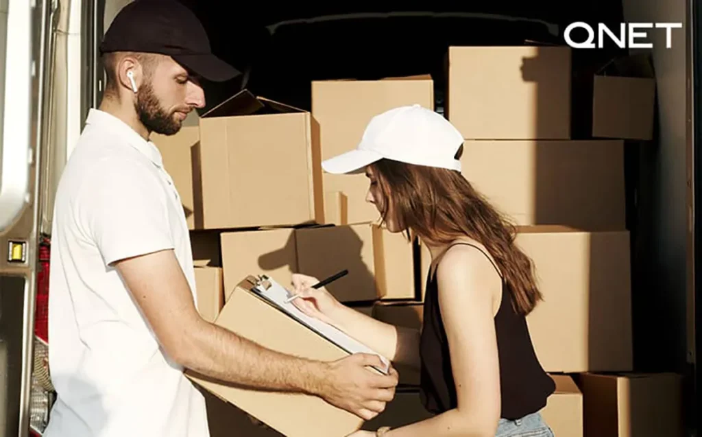 A delivery man delivering a QNET product to a customer. QNET scam