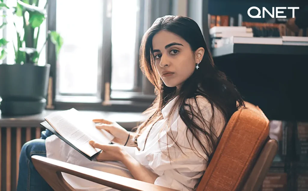 A young woman reading Harry Potter series