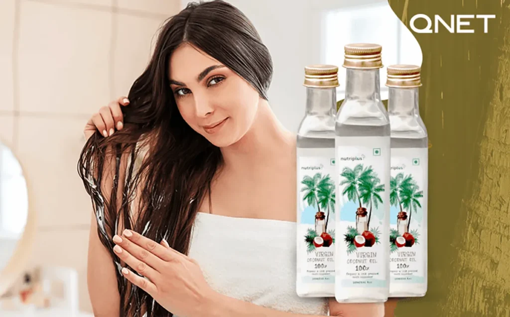 A woman presenting the Nutriplus virgin coconut oil basic pack