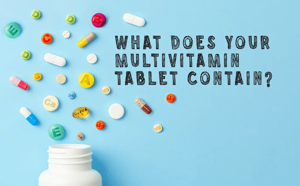 Pills and multivitamin capsules in wooden spoon with fresh fruits in the background
