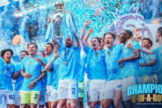 Manchester City squad celebrates their unprecedented fourth consecutive Premier League championship Four-In-A-Row
